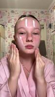 Close-up of young woman using hands to massage skincare on her nose, focusing on improving skin texture and treating specific areas, a gentle beauty routine for flawless skin video