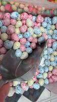 Easter Colomba cake crumbs scattered on white surface with colorful speckled mini Easter eggs video