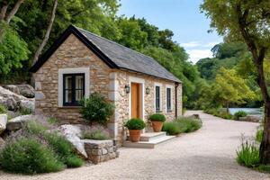 Charming stone cottage nestled in idyllic riverside setting with lush landscaping photo