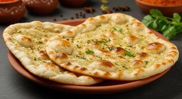 Delicious naan bread served on a plate photo