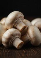 Fresh button mushrooms close up on a wooden surface photo
