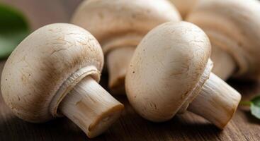 Fresh button mushrooms on a wooden table photo
