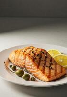 Grilled salmon fillet with capers and lemon slices photo