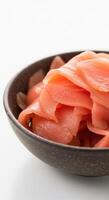 Close up of pickled ginger in a bowl ready to be enjoyed. photo