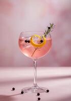 Elegant pink cocktail with a lemon twist garnish photo