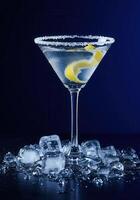 A sophisticated martini with a lemon twist, garnished with sugar and ice photo