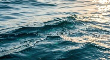 Ocean waves gently rolling in the sunlight, creating a calming scene. photo