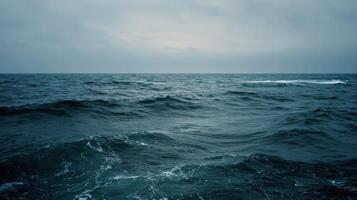A Calm And Wide Open Ocean Under An Overcast Sky photo