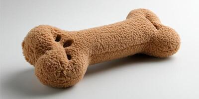 A stuffed dog bone on a white surface photo