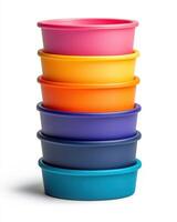 A stack of colorful plastic bowls on a white background photo