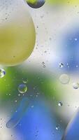 Rotating liquid spheres chromatic dance. vertical frame video