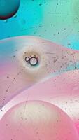 Rotating liquid spheres ethereal chromatic dance. vertical frame video