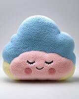 A blue and pink cloud shaped pillow with eyes closed photo