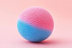 A pink and blue sponge ball on a pink background photo