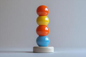 A stack of colorful eggs on top of a white base photo