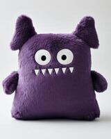 A purple monster pillow with eyes and big eyes photo