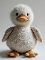 A stuffed white duck with brown feet photo