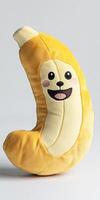A banana shaped pillow with a smiling face photo