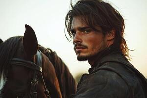 A man with long hair and a leather jacket is standing next to a horse photo