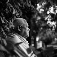 Older man contemplates nature in a black and white outdoor portrait photo