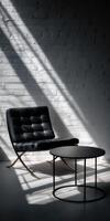 Modern black leather chair and round table in light and shadow photo