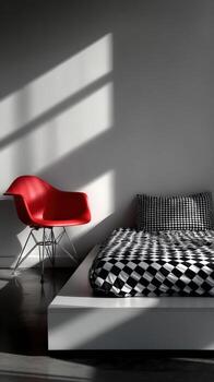 Red chair and bed with checkered pattern in minimalist bauhaus room photo