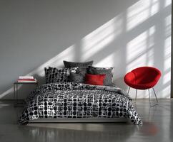 Stylish bedroom with bauhaus inspired bedding and modern red chair photo