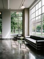 Bauhaus architectural interior with sofa near large windows photo