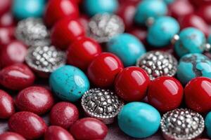 Colorful assortment of red and turquoise beads with metallic accents, showcasing intricate textures and vibrant hues, perfect for jewelry design and creative projects photo