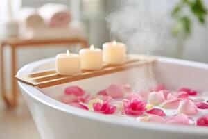 Steaming bath with rose petals and candles on wooden tray photo