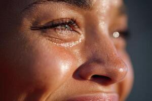 Athlete crying and smiling while sweating under sunlight photo