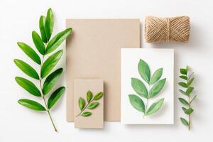 Eco-friendly branding mockup with recycled paper and green leaves photo