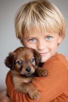 Young boy with blonde hair is joyfully holding a small brown puppy in his arms, showcasing a heartwarming bond between child and pet in a cozy indoor setting photo