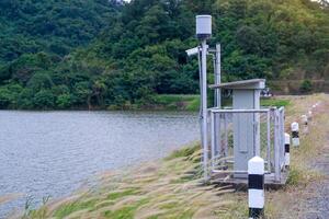 Solar automatic water metering station or water level meter used to measure the water level of a reservoir to help alert villagers to watch out for flooding if the flood level reaches the meter. photo