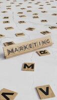 Vertical Animation of the Word Marketing Formed with Scrabble Tiles on a Marble Surface video