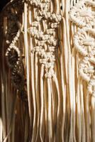Intricate macrame design showcasing craftsmanship in neutral tones and textures photo