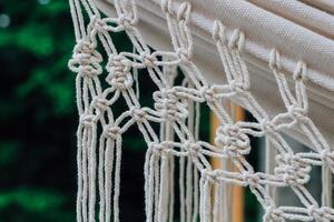 Crafting intricate macrame patterns in natural light during a serene afternoon photo