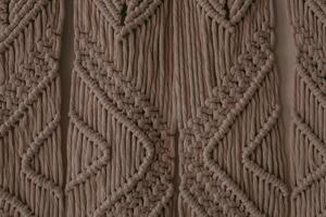 Intricate macrame wall hanging showcasing detailed patterns and textures in neutral tones photo