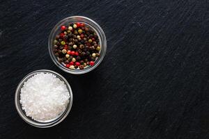 Spices and salt on dark surface for culinary preparation and seasoning photo