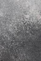 Surface texture of dark stone with subtle patterns in natural light setting photo