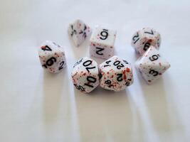 A collection of various multi-faceted game white cubes with numbers photo