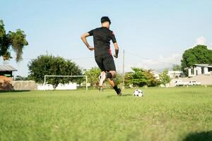 Latin american soccer player dribbling ball on field showing skill and dedication photo