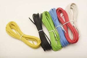 Multicolored jumper wires for breadboards. Coils of multicolored wires. Connecting wires for electronics. photo