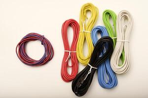 Glowing RGB wires in a dark setup. Coils of multicolored wires. Connecting wires for electronics. photo