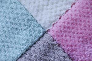 Close-up of fluffy towel texture. Background of colorful towels. Several soft terry towels. photo