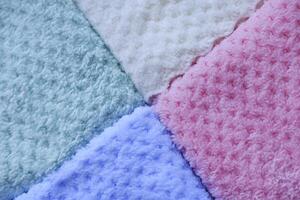 Colorful towels on white background. Background of colorful towels. Several soft terry towels. photo
