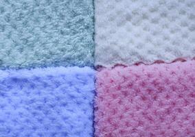 Tropical-print towels on a lounger. Background of colorful towels. Several soft terry towels. photo
