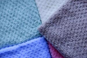 Rainbow-colored towels flat lay. Multi-colored pile towels. A soft towel. photo