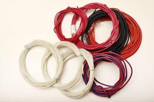 Striped and patterned electronic wires. Bundles of copper connecting wires in rubber insulation. Multicolored wires. photo