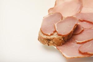 Ham sandwiches. Ham cut into thin slices. Open-faced sandwich with rare roast beef photo